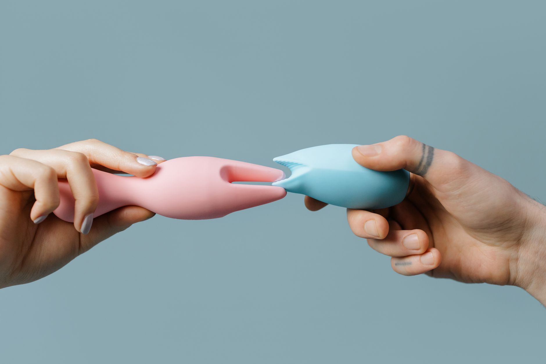 Hands holding pastel-colored silicone toys